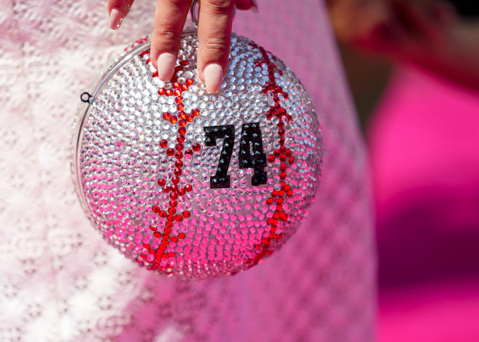 Gianni Jansen, wife of American League's Kenley Jansen, of the Boston Red Sox, holds a custom clutch with Kenley's jersey number during the All-Star Game red carpet show, Tuesday, July 11, 2023, in Seattle. (AP Photo/Lindsey Wasson)