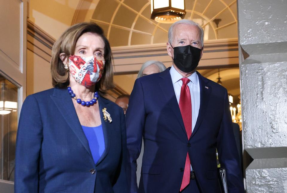 President Joe Biden walks with House Speaker Nancy Pelosi, D-Calif., as he arrives to meet with House Democrats at the U.S. Capitol on Oct. 1, 2021 in Washington, D.C. Biden called the meeting in order to push through an impasse with his infrastructure plan with $550 billion in new spending.