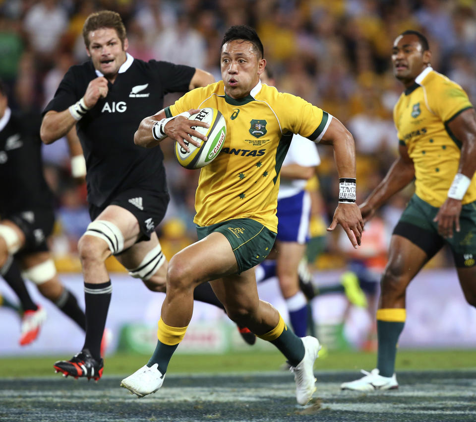 FILE - Australia's Christian Leali'ifano, center, runs away from New Zealand's Richie McCaw during their Bledisloe cup rugby match in Brisbane, Australia on Oct. 18, 2014. The long-awaited debut of Christian Leali'ifano's Moana Pasifika team in Super Rugby has been further delayed, Tuesday, Feb. 22, 2022, by the postponement of the team's scheduled second round match on Sunday against the Chiefs. (AP Photo/Tertius Pickard, File)