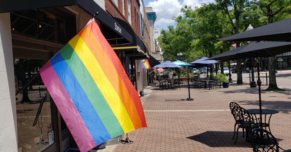 Businesses along Hay Street in downtown Fayetteville display Pride flags on Monday afternoon, June 21, 2021. LGBTQ+ couples in Cumberland County can choose from a variety of affirming vendors to plan a local wedding.