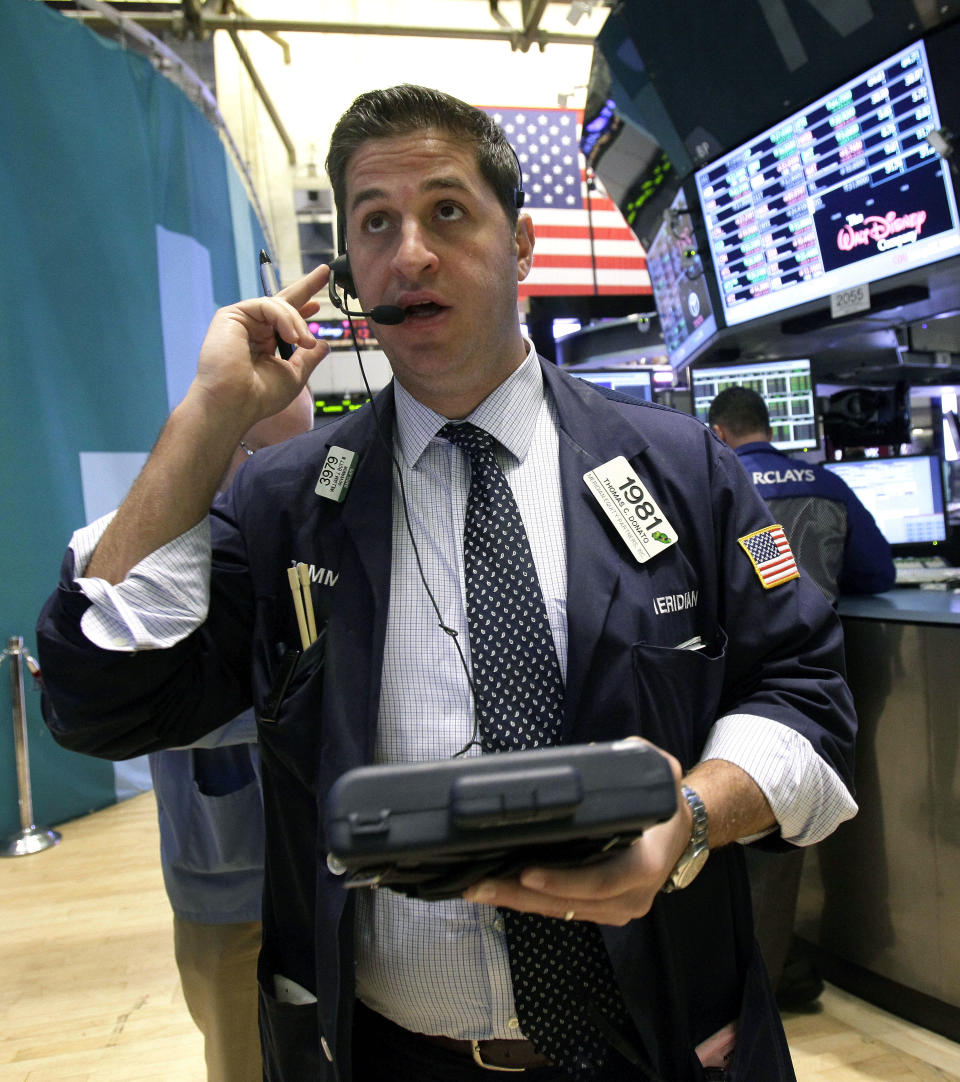 Trader Thomas Donato works on the floor of the New York Stock Exchange Monday, Oct. 22, 2012. A weak forecast from heavy equipment maker Caterpillar and other poor earnings results weighed on the U.S. stock market in early trading. (AP Photo/Richard Drew)