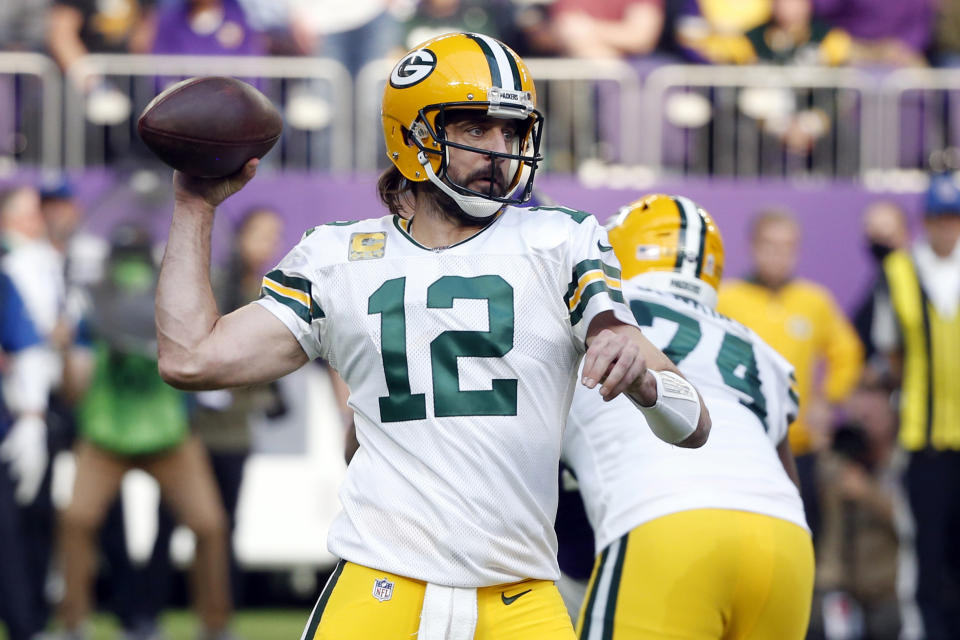 FILE - Green Bay Packers quarterback Aaron Rodgers (12) throws a pass during the first half of an NFL football game against the Minnesota Vikings, on Nov. 21, 2021, in Minneapolis. Rodgers was named to The Associated Press 2021 NFL All-Pro Team, announced Friday, Jan. 14, 2022.(AP Photo/Bruce Kluckhohn, File)