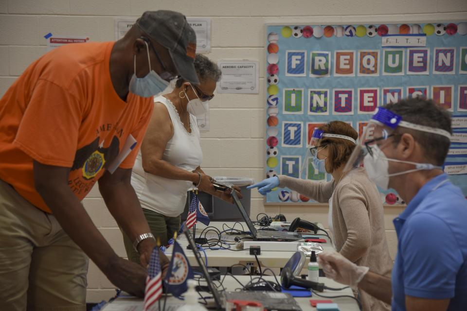 Black voters take to the polls to cast ballots. (Photo by Jahi Chikwendiu/The Washington Post via Getty Images)