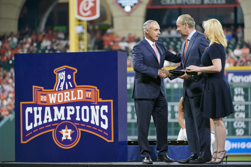 Rob Manfred, seen here presenting Astros owner Jim Crane with his World Series ring, says MLB investigators looked into complaints about Houston's sign-stealing habits, but didn't find evidence of wrongdoing until Mike Fiers went to the media. (Photo by Cooper Neill/MLB via Getty Images)