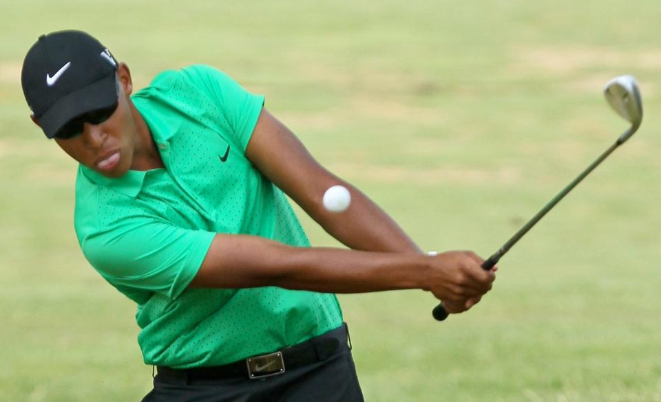 Chase Johnson hits a chip shot to the green on the second hole while participating in the final round of the Good Park Junior Golf Tournament at Good Park Golf Course on July 13, 2012, in Akron.