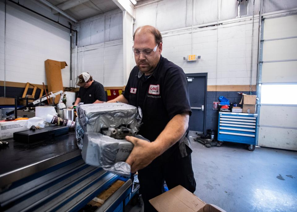 Auto technician, Mitch Lickteig works on  the lifters of  a 2015 GMC Sierra truck  at the Landers Buick GMC in Southaven, MS Saturday, Oct. 11, 2019.