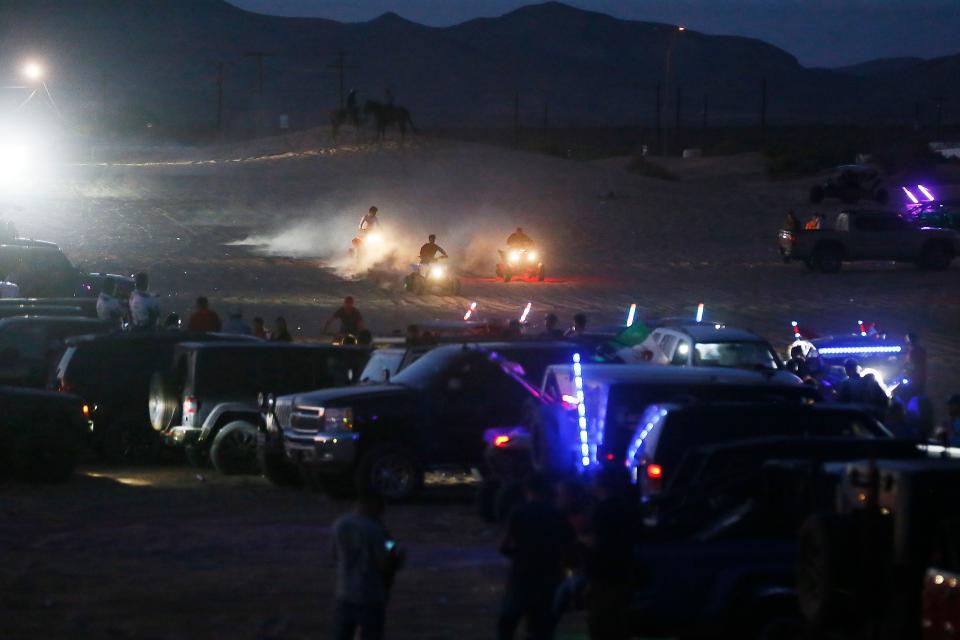 People ride ATVs and four-wheel drive vehicles in the Red Sands desert east of El Paso in the summer of 2021 in this file photo.