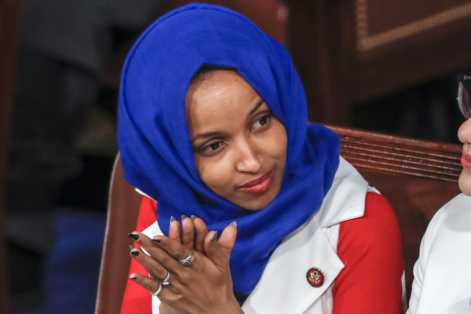 FILE - In this Feb. 5, 2019, file photo, Rep. Ilhan Omar, D-Minn., listens to President Donald Trump's State of the Union speech, at the Capitol in Washington. Omar "unequivocally" apologized Monday, Feb. 11, 2019, for tweets suggesting that members of Congress support Israel because they are being paid to do so, which drew bipartisan criticism and a rebuke from House Speaker Nancy Pelosi. (AP Photo/J. Scott Applewhite, File)