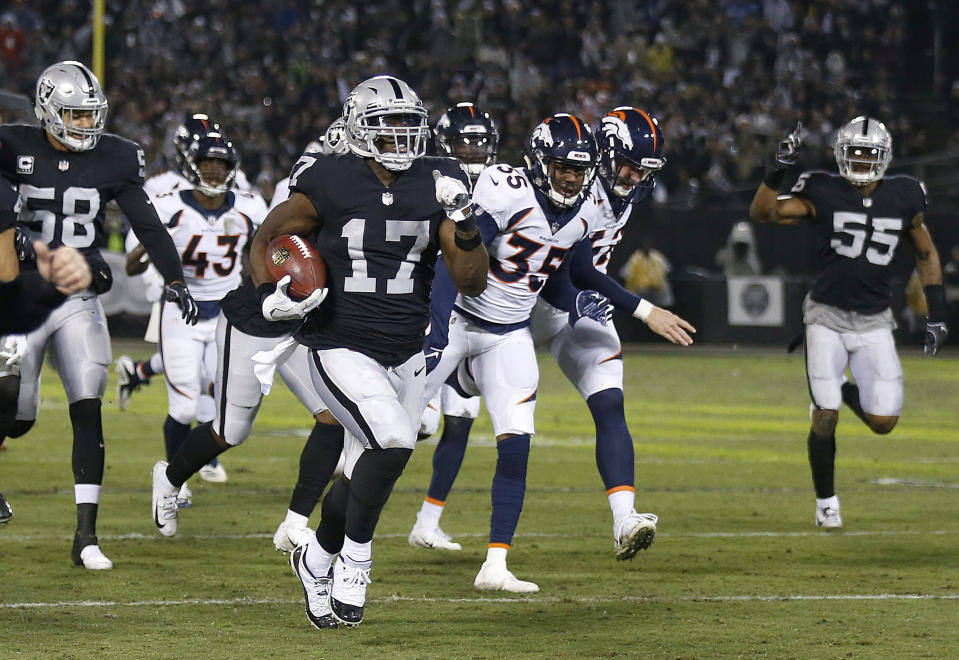 Oakland Raiders' Dwayne Harris (17) returns a punt for a touchdown against the Denver Broncos during the first half of an NFL football game in Oakland, Calif., Monday, Dec. 24, 2018. (AP Photo/D. Ross Cameron)