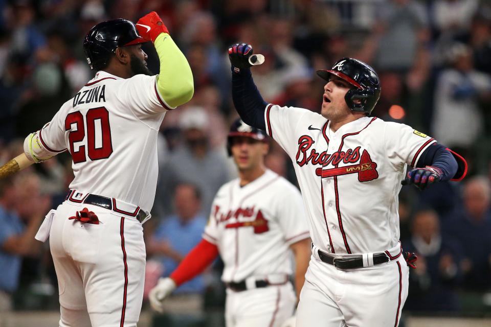 Atlanta Braves third baseman Austin Riley, right, celebrates with designated hitter Marcell Ozuna (20) after hitting a go-ahead, two-run home run in the eighth inning against the Philadelphia Phillies during Game 2 of the NLDS.