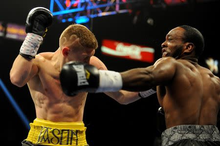 Jul 12, 2014; Las Vegas, NV, USA; Jason Quigley (yellow trunks) and Howard Reece (black trunks) exchange blows during a middleweight fight at MGM Grand. Mandatory Credit: Stephen R. Sylvanie-USA TODAY Sports