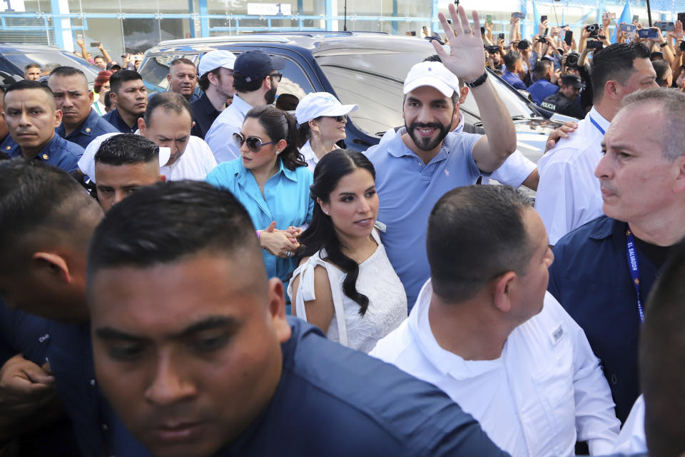 El Salvador President Nayib Bukele, who is seeking re-election, waves upon his arrival with his wife Gabriela Rodriguez to a polling station to vote in general elections in San Salvador, El Salvador, Sunday, Feb. 4, 2024. (AP Photo/Salvador Melendez)
