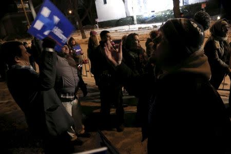 Supporters (L) for U.S. presidential Democratic candidate Hillary Clinton show their support before a U.S. Democratic presidential candidates debate in Milwaukee, Wisconsin, United States February 11, 2016. REUTERS/Darren Hauck