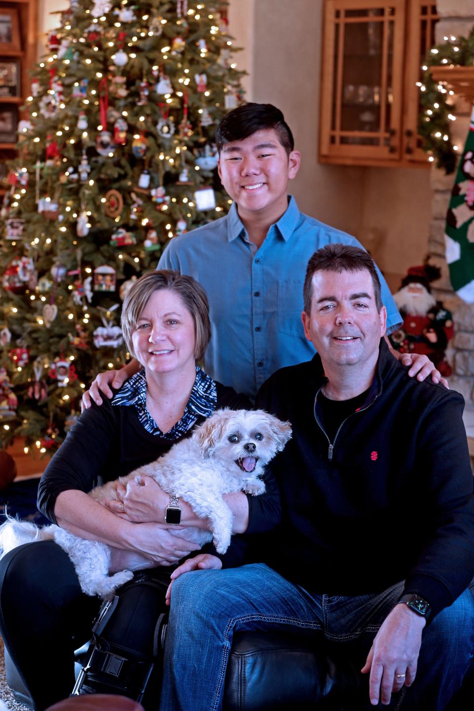 The Mitchell family from left Terri, holding Snickers, Nick and Bill are shown this month in their extensively decorated Sussex home.