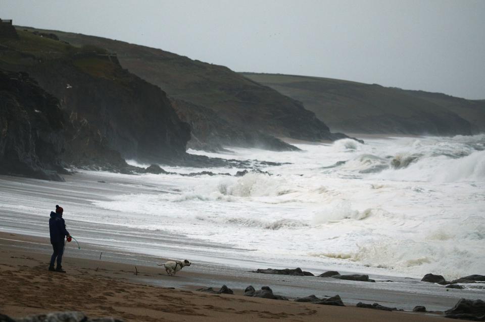 Waves break at sunrise as the tail end of Hurricane Epsilon brings strong winds and heavy rain to Porthleven (REUTERS)