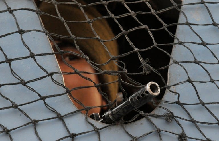 An Indian soldier stands guard in Srinagar on January 22, 2013. Police in Indian Kashmir have warned residents to build underground bunkers to prepare for a possible nuclear war in the disputed region, which is on edge after a string of deadly border clashes