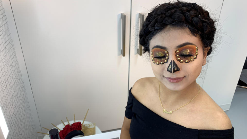 She uses the same eyeliner to draw the sugar skull’s nose. (Photo: Gisselle Bances)