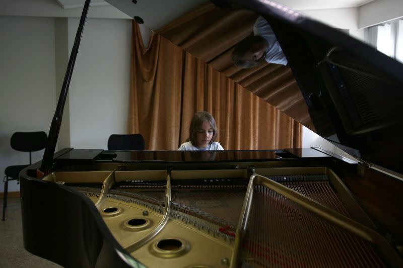 Stelios Kerasidis, 7-year-old pianist and composer, plays the piano during a lesson at the Athens Megaron Concert Hall in Athens