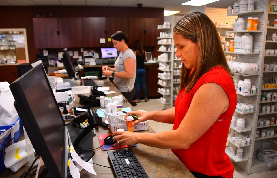 Jessica Beal, a pharmacist at Hobbs Parmacy on merritt Island, fills a customers prescriprtion order. The role of the pharmacist has changed during COVID, with pharmacists doing more vaccines, testing and consulting with customers.   