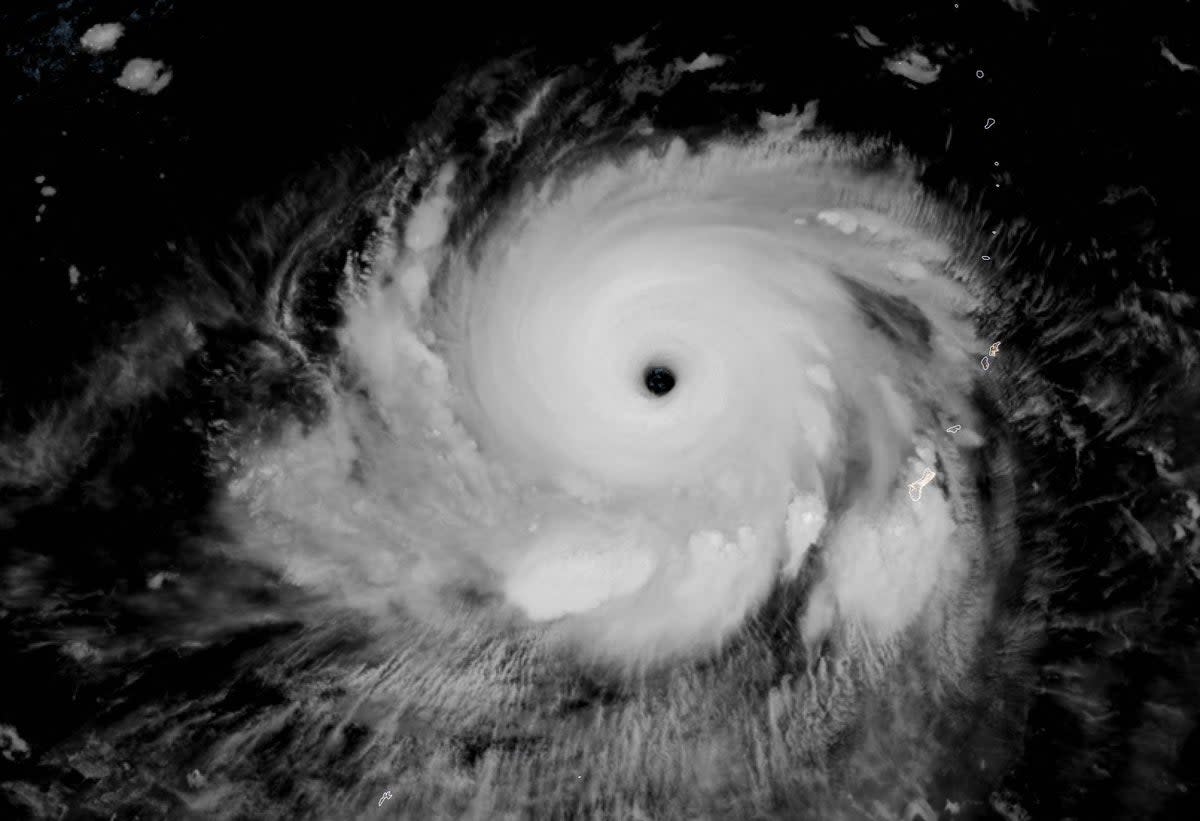 'This satellite image obtained from the The National Oceanic and Atmospheric Administration shows Typhoon Mawar as it moves away from Guam  (NOAA)