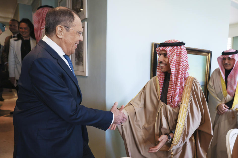 In this handout photo released by Russian Foreign Ministry Press Service, Russian Foreign Minister Sergey Lavrov, left, and Minister of Foreign Affairs of Saudi Arabia Prince Faisal bin Farhan Al-Saud, shake hands during their meeting on the sideline of a BRICS Foreign Ministers meeting in Cape Town, South Africa, Thursday, June 1, 2023. (Russian Foreign Ministry Press Service via AP)