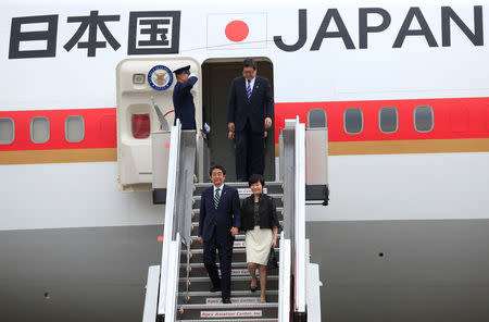 Japanese Prime Minister Shinzo Abe and his wife Akie Abe disembark from the plane upon their arrival for a state visit in metro Manila, Philippines January 12, 2017. REUTERS/Romeo Ranoco