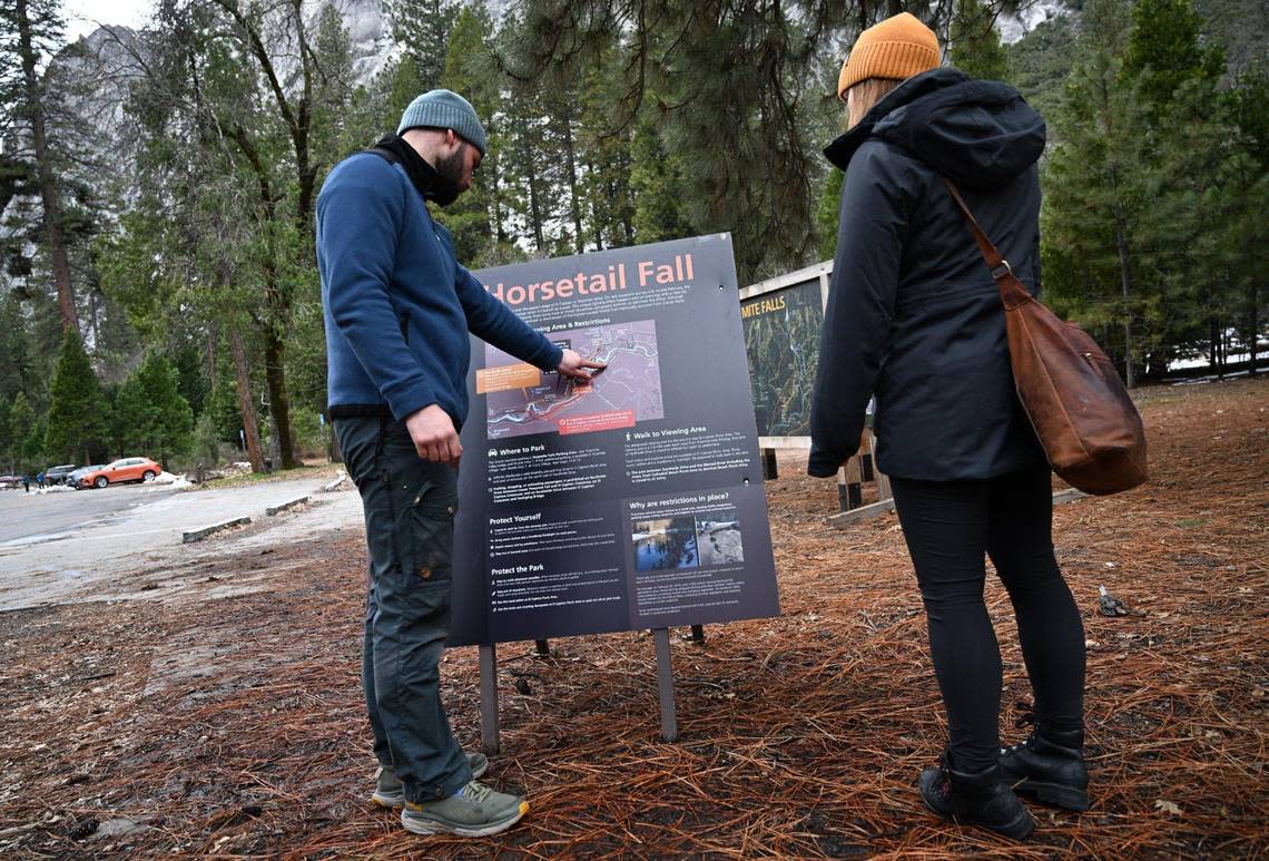 Visitors from Ireland interested in viewing the annual Firefall read an informational post located near Yosemite Lodge in Yosemite Valley Friday, Feb 9, 2024 in Yosemite National Park. ERIC PAUL ZAMORA/ezamora@fresnobee.com