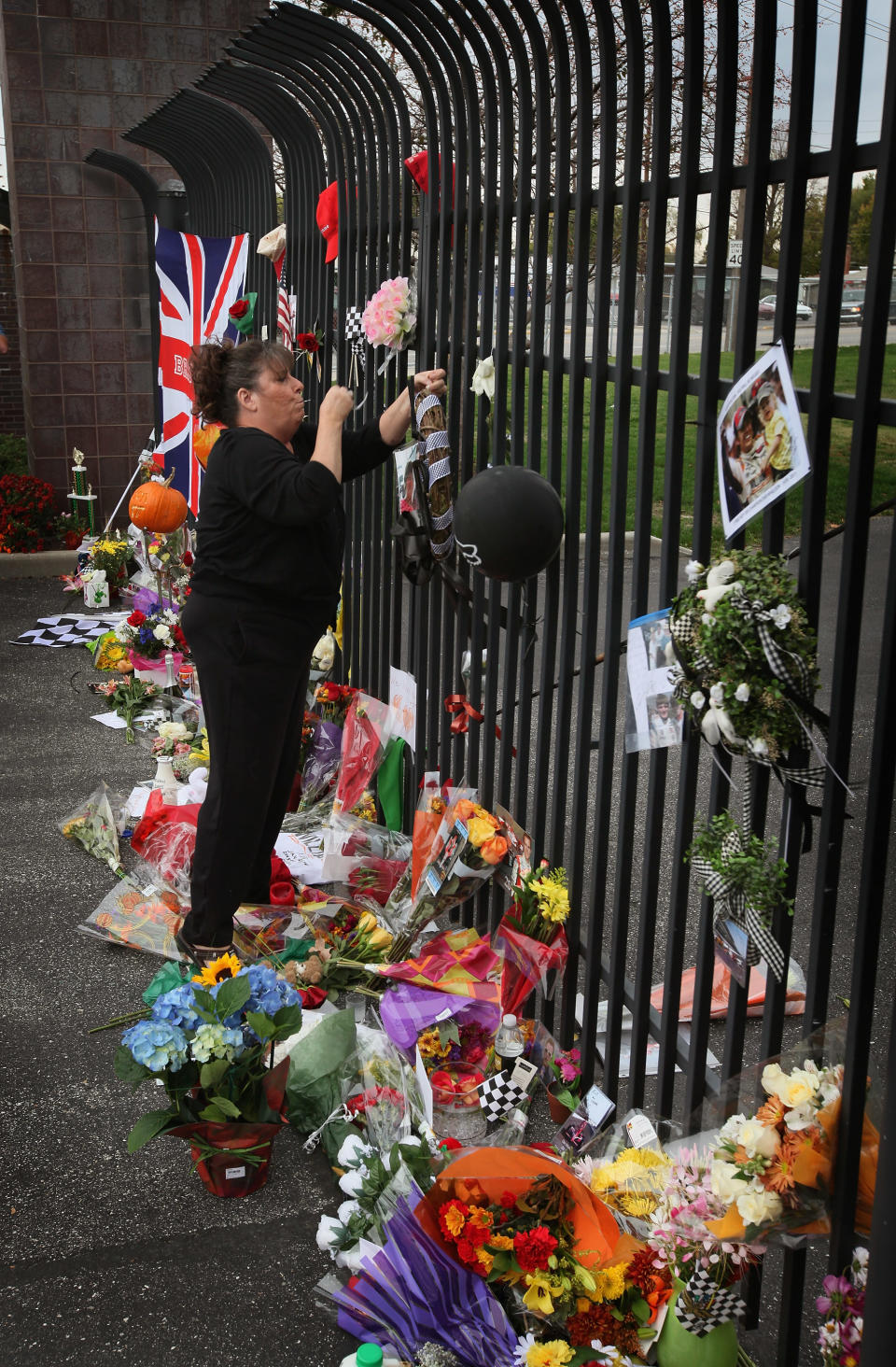 INDIANAPOLIS, IN - OCTOBER 17: A race fan leaves a tribute to two-time Indianapolis 500 winner Dan Wheldon at the gate of the Indianapolis Motor Speedway on October 17, 2011 in Indianapolis, Indiana. Wheldon, winner of the 2005 and 2011 Indy 500 races, was killed in a crash yesterday at the Izod IndyCar series season finale at Las Vegas Motor Speedway. (Photo by Scott Olson/Getty Images)