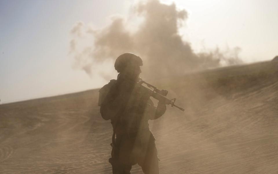 An Israeli soldier stands near the Gaza Strip border in southern Israel