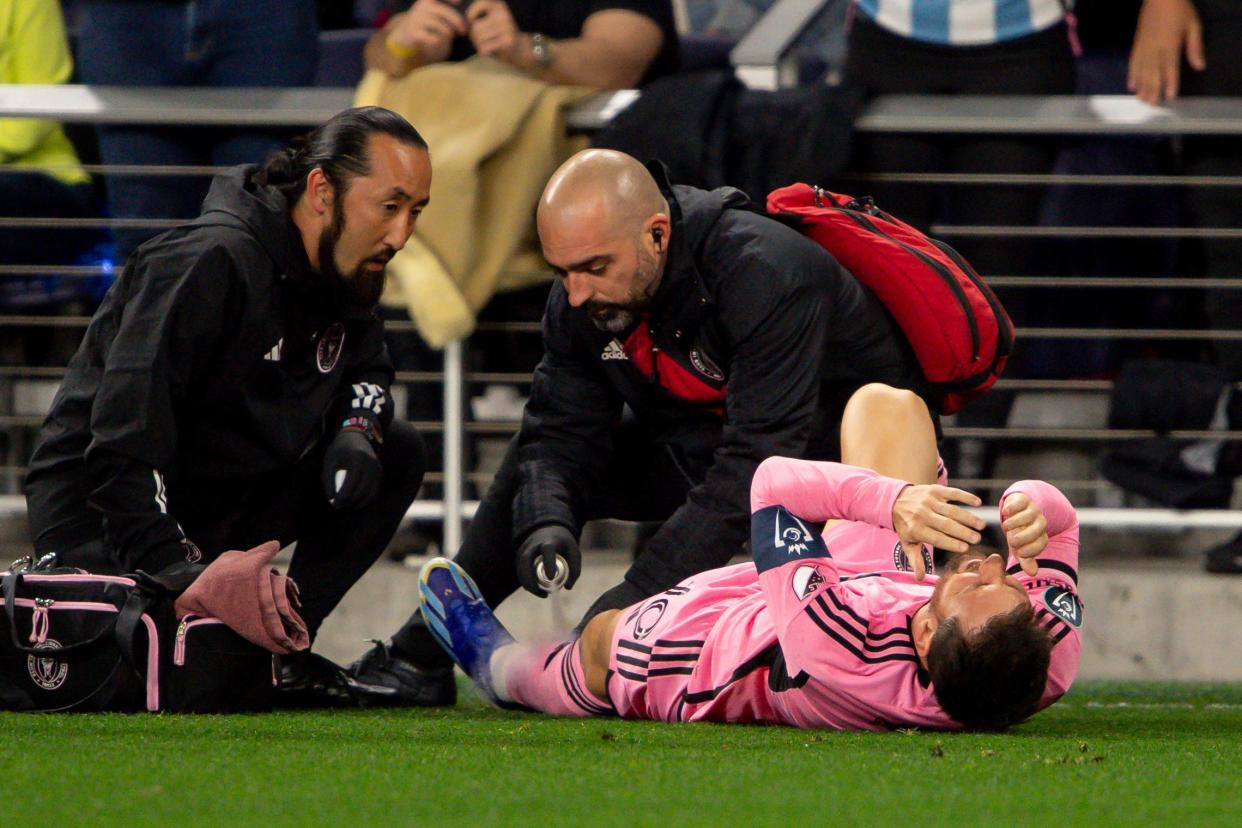 Lionel Messi gets looked at by trainers during the Concacaf Champions Cup first leg match against the Nashville SC at GEODIS Park in Nashville.