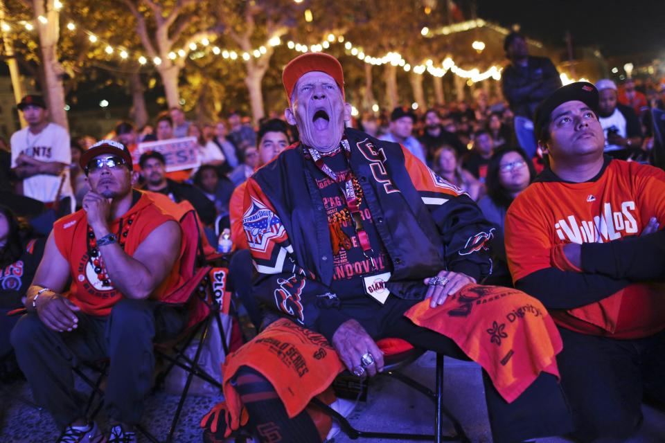 Fans watch the San Francisco Giants and the Kansas City Royals play the World Series during a television viewing event at the Civic Center in San Francisco