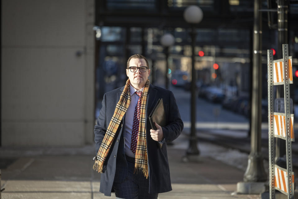 Jeff Storms, attorney for George Floyd's family, makes his way to the Warren E. Burger Federal Building as jury selection begins in St. Paul, Minn., Thursday, Jan. 20, 2021. Jury selection began Thursday in the federal trial of three Minneapolis police officers charged in George Floyd’s killing, with the judge stressing repeatedly that fellow Officer Derek Chauvin's conviction on state murder charges and guilty plea to a federal civil rights violation should not influence the proceedings. (Elizabeth Flores/Star Tribune via AP)