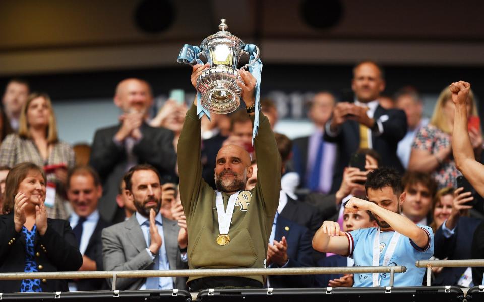 Pep Guardiola, Manager of Manchester City, lifts the FA Cup Trophy - Getty Images/Michael Regan 