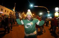 A Saskatchewan Roughriders fan celebrates after his team beat the Hamilton Tiger-Cats in the CFL's 101st Grey Cup championship football game in Regina, Saskatchewan November 24, 2013. REUTERS/David Stobbe (CANADA - Tags: SPORT FOOTBALL)