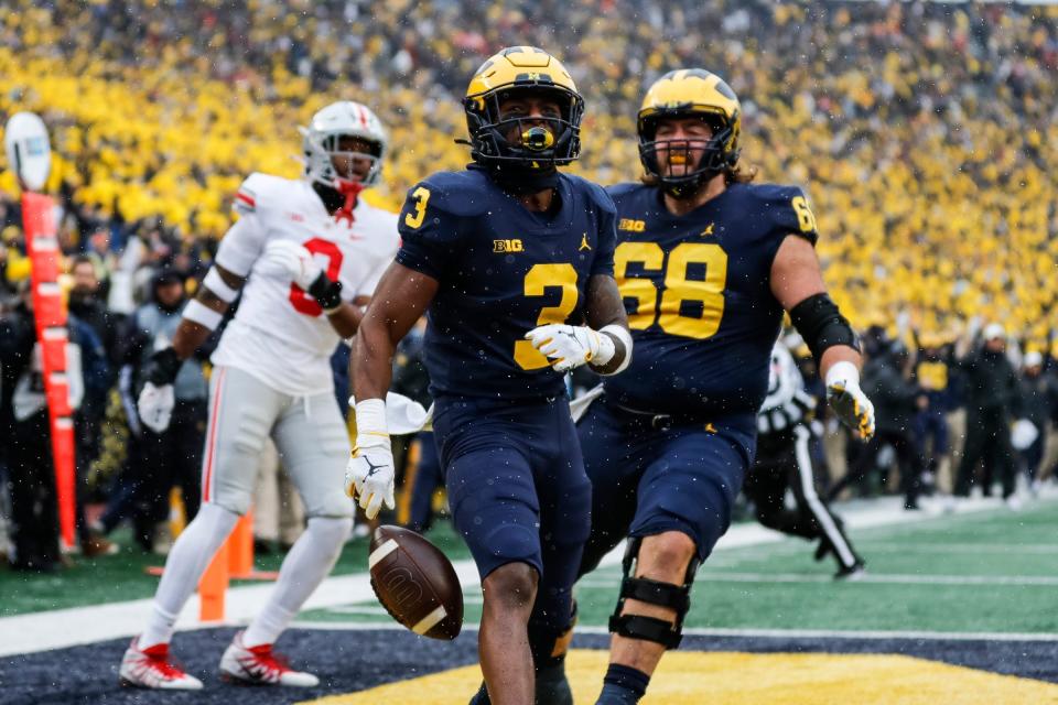 Michigan receiver A.J. Henning (3) celebrates with offensive lineman Andrew Vastardis (68) after scoring a touchdown and during the first quarter against Ohio State at Michigan Stadium in Ann Arbor on Saturday, Nov. 27, 2021.