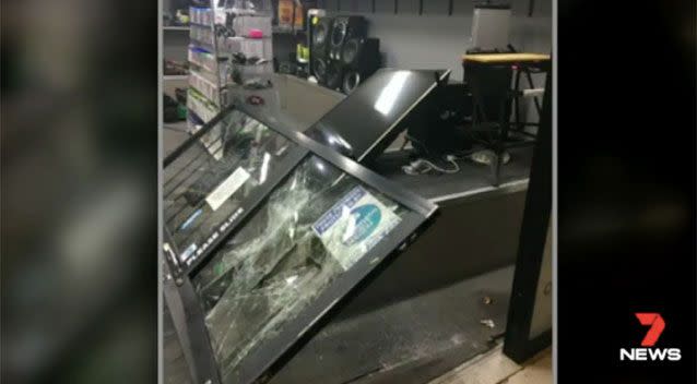 The damage to the Logan store's doors. Source: 7 News