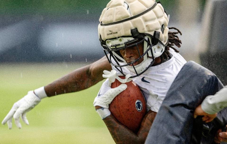 Penn State wide receiver KeAndre Lambert-Smith runs a drill as it starts to rain during practice on Sunday, Aug. 6, 2023.