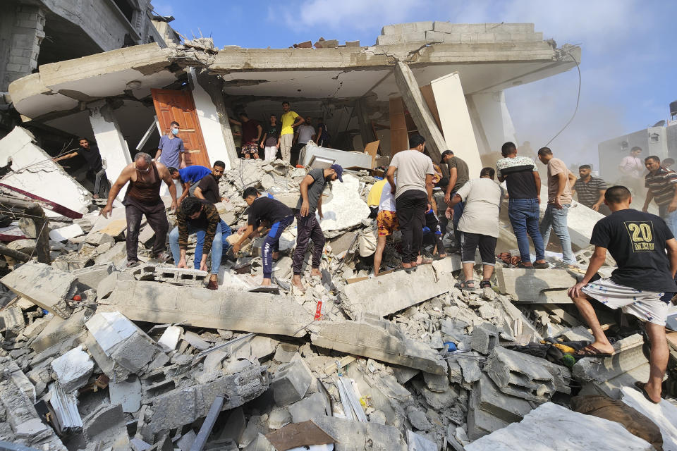 Palestinians look for survivors in the rubble of a destroyed building following an Israeli airstrike in Bureij refugee camp, Gaza Strip, Thursday, Nov. 2, 2023. (AP Photo/Hassan Eslaiah)