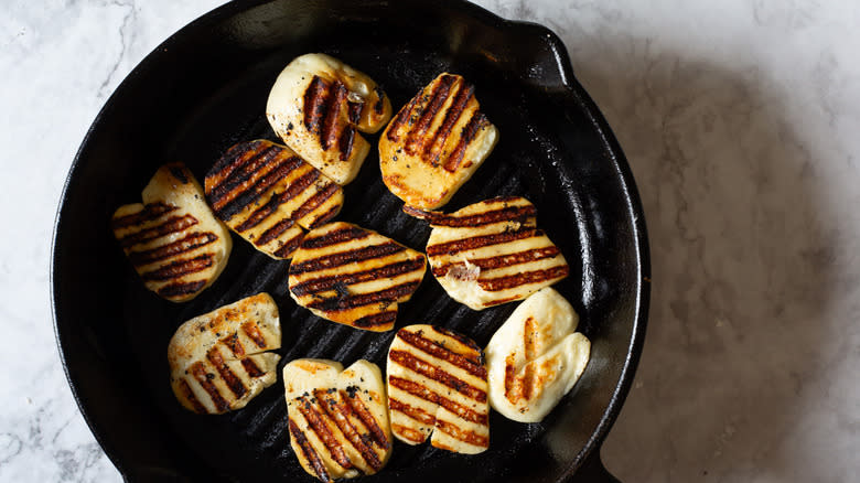 Fried halloumi slices in pan