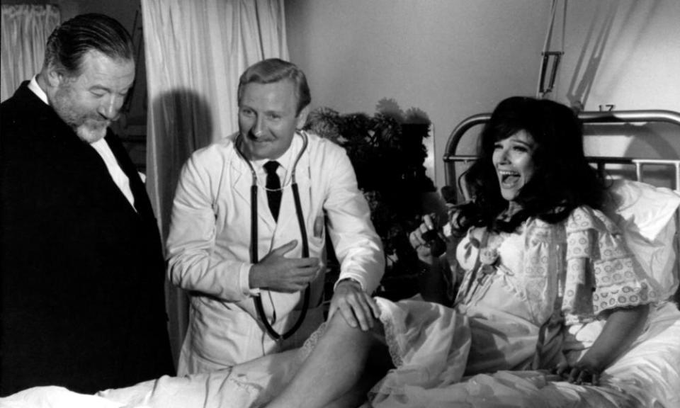 Leslie Phillips, center, with James Robertson Justice and Fenella Fielding in Doctor in Clover, 1966.