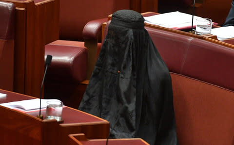 One Nation Leader Senator Pauline Hanson wears a full Islamic burqa veil in the Senate chamber at Parliament House in Canberra - Credit: AAP