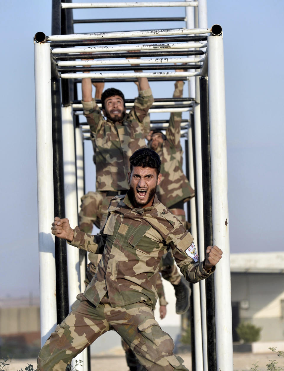 FILE - In this Sept. 11, 2018, file photo, Turkey-trained Syrian opposition fighters of the National Army group, formally known as Free Syrian Army, train in a camp in the Turkish-controlled northwestern city of Azaz, Syria. The violence raging once again in the northwestern province of Idlib, Syria's last rebel-held bastion, is putting Turkish-Russian relations to the test. (Ugur Can/DHA via AP, File)