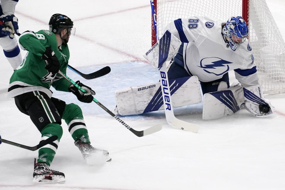 Dallas Stars center Jason Dickinson (18) looks on as Tampa Bay Lightning's Andrei Vasilevskiy (88) gloves a shot in the second period of an NHL hockey game in Dallas, Tuesday, March 2, 2021. (AP Photo/Tony Gutierrez)