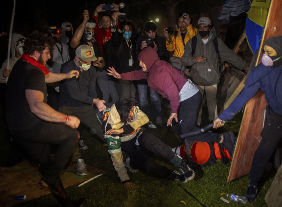 Demonstrators clash at an encampment at UCLA early Wednesday, May 1, 2024, in Los Angeles.  (Ethan Swope/AP)