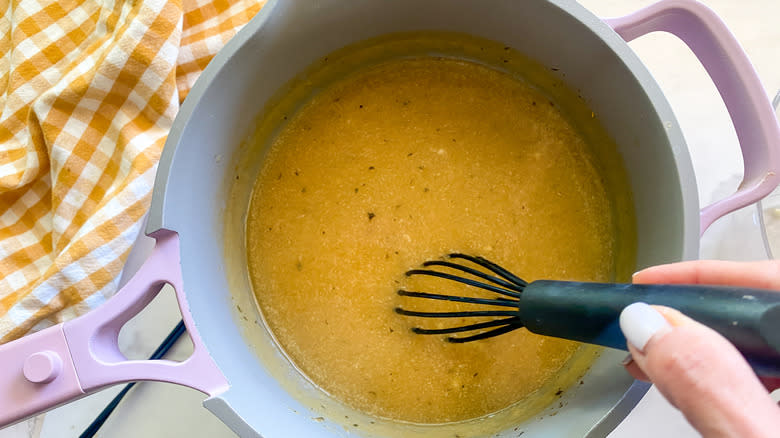 stirring gravy in pot