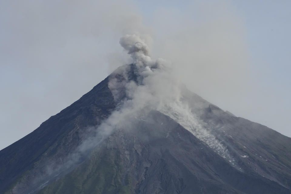 Mayon volcano spews ash and lava as seen from Daraga town, Albay province, northeastern Philippines, Wednesday, June 14, 2023. The 2,462-meter (8,077-foot) Mayon is a top tourist draw in the Philippines because of its picturesque conical shape but is the most active of 24 known volcanoes in the archipelago. (AP Photo/Aaron Favila)