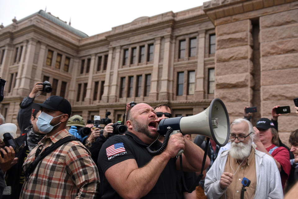 Alex Jones screams into a megaphone as protesters against the state's extended stay-at-home order to help slow the spread of the coronavirus disease (COVID-19) demonstrate at the Capitol building in Austin, Texas, April 18, 2020. (Photo: Callaghan O'Hare / Reuters)