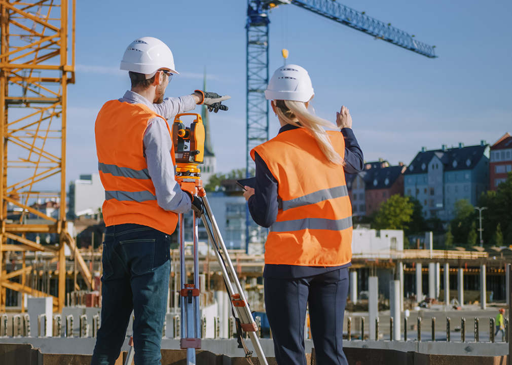 Site Engineer using surveying equipment.