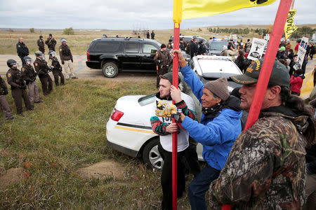 Dakota Access Pipeline protesters square off against police between the Standing Rock Reservation and the pipeline route outside the little town of Saint Anthony, North Dakota, U.S., October 5, 2016. REUTERS/Terray Sylvester