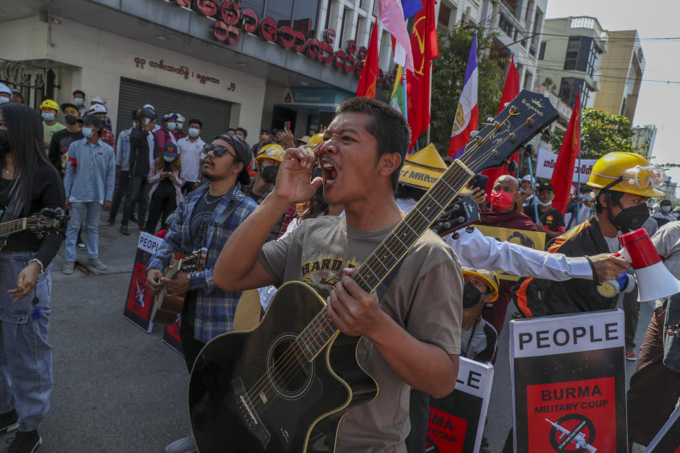 An anti-coup protester shout slogans after riot policemen blocked their march in Mandalay, Myanmar, Wednesday, Feb. 24, 2021. Protesters against the military's seizure of power in Myanmar were back on the streets of cities and towns on Wednesday, days after a general strike shuttered shops and brought huge numbers out to demonstrate. (AP Photo)